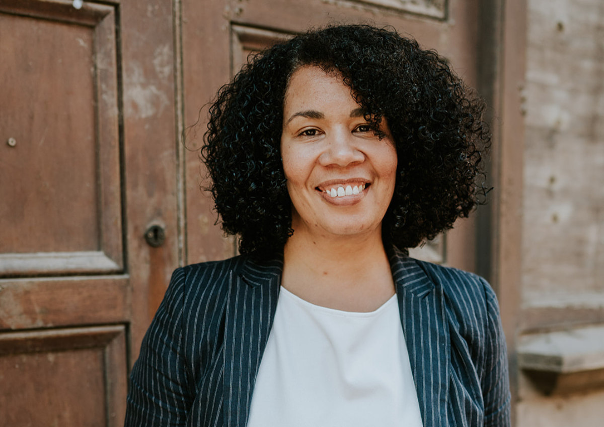 A confident professional standing outside in natural light, symbolising renewed self-belief and personal growth