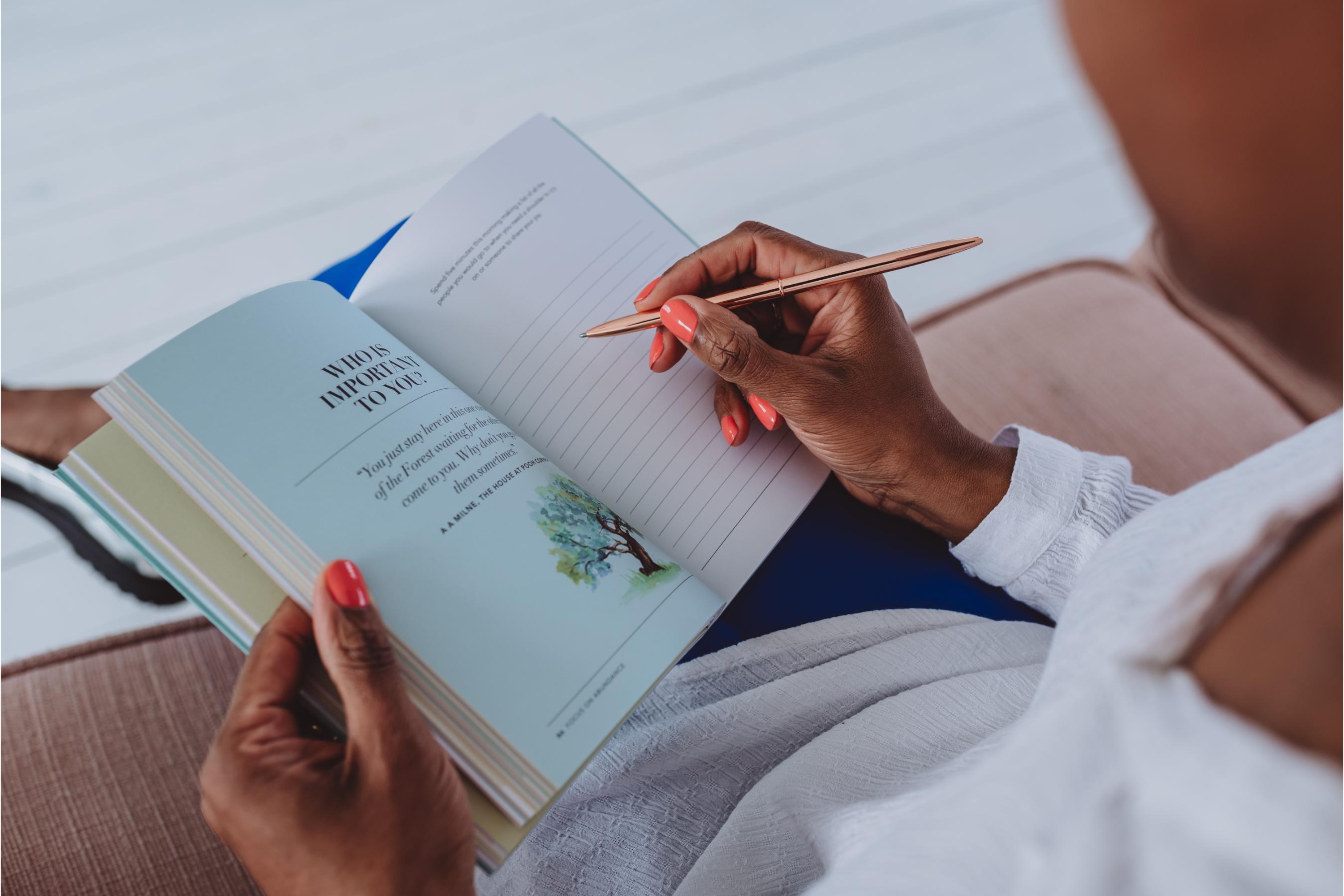 a woman writing in a journal