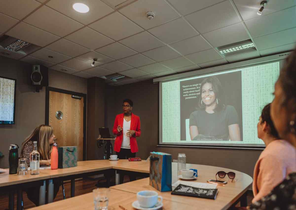 Confident entrepreneur speaking to a group or networking with other professionals at a business event