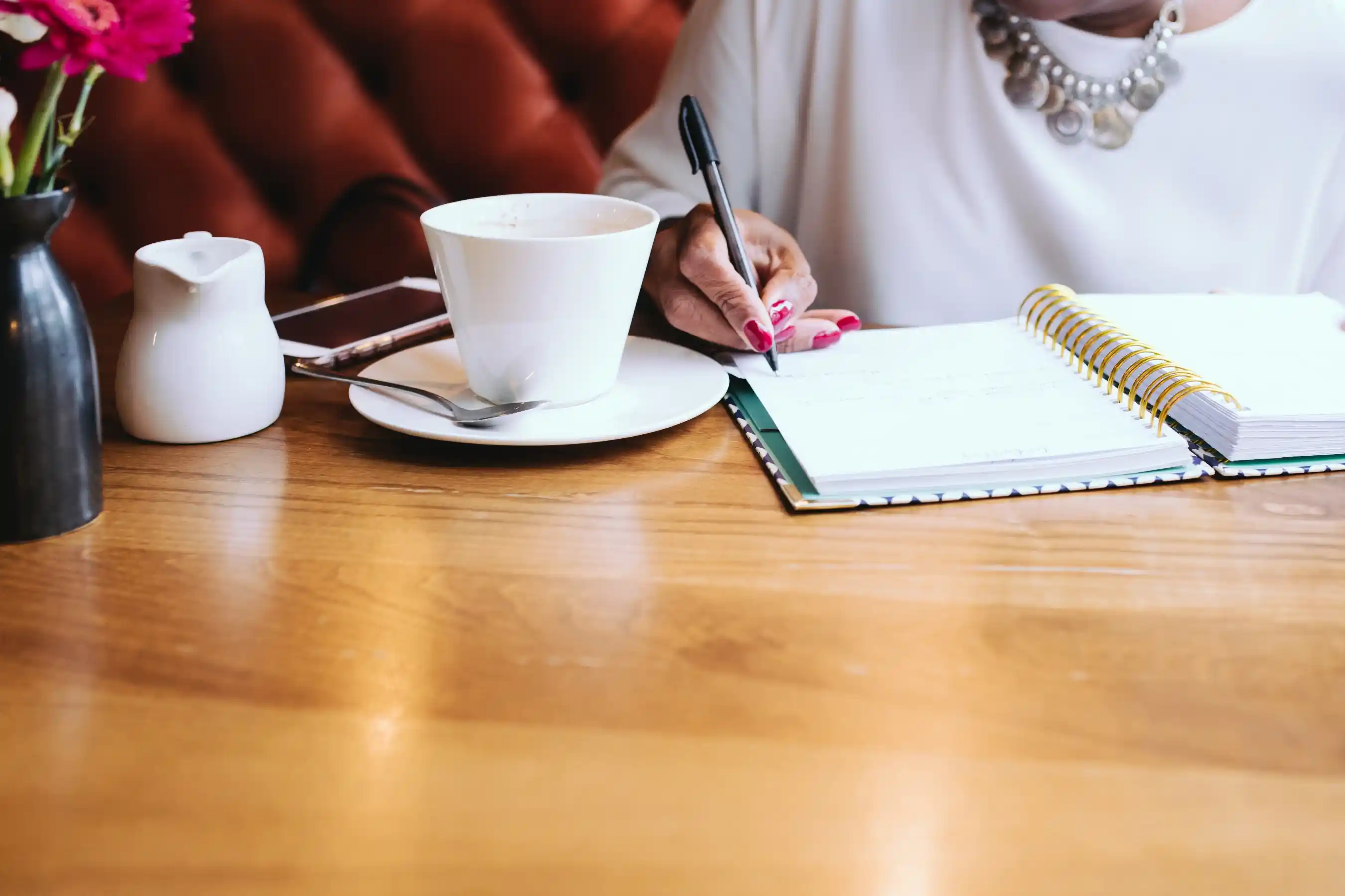 business coach writing notes in a calm coaching session